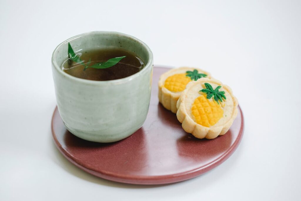 black tea with tasty sweet pastries on a plate