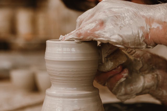 hands making pottery