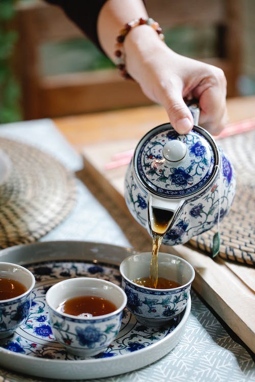 tea being poured from a ceramic tea pot