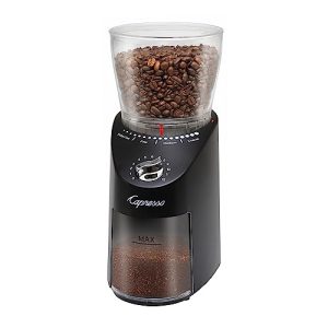 A coffee grinder with coffee beans on it.