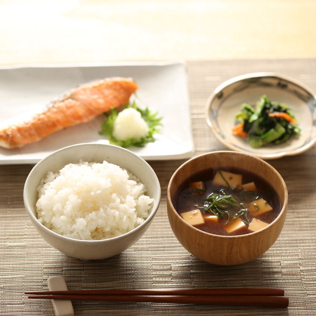 A set of Japanese breakfast lies serenely on a dining table
