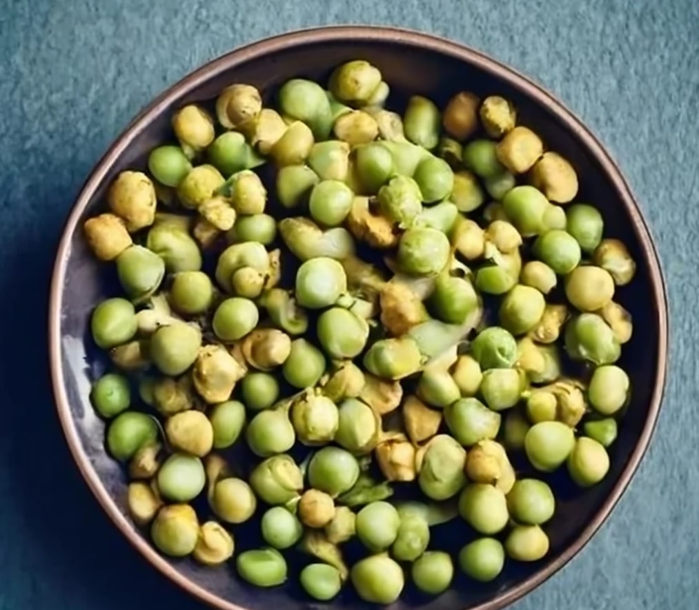 Wasabi peas in a bowl on a table.