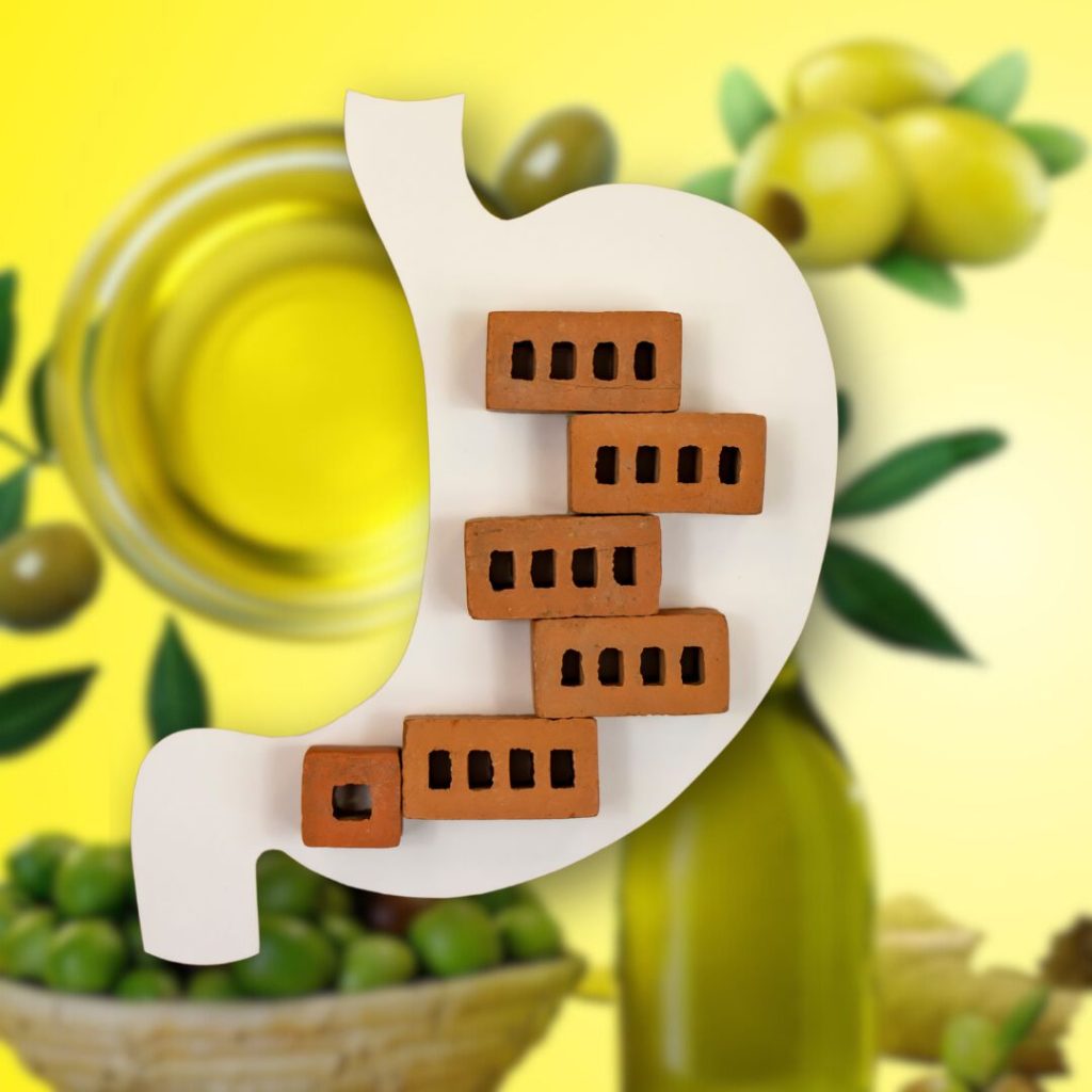 A visual depiction of a constipated stomach is contrasted against a backdrop of extra virgin olive oils and olives.