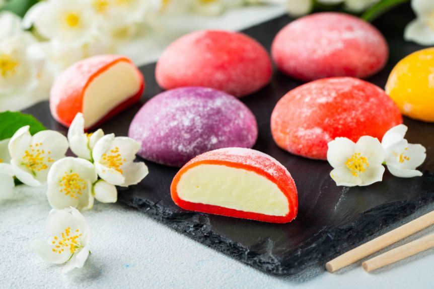 Colorful Japanese mochi rice with flower decorations around it.